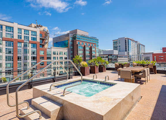 A pool on a balcony with a metal railing.