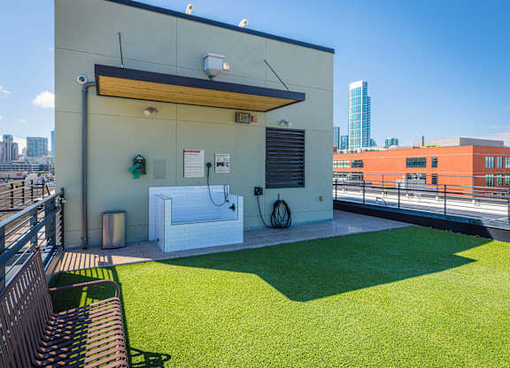 A small white building with a green lawn in front.