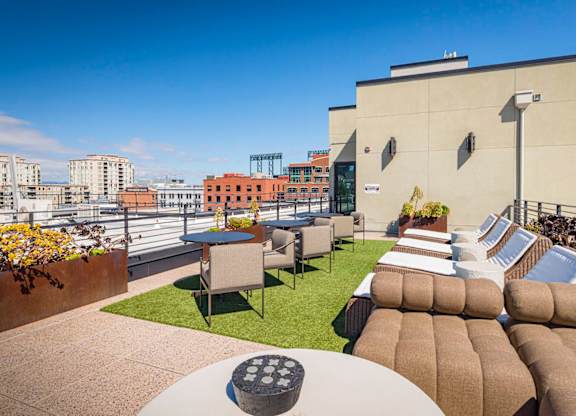 A patio with a table and chairs overlooking a city street.