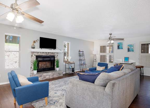A living room with a fireplace, a couch, and a television.