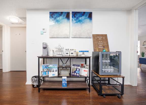 A room with a table and a display of items for sale.