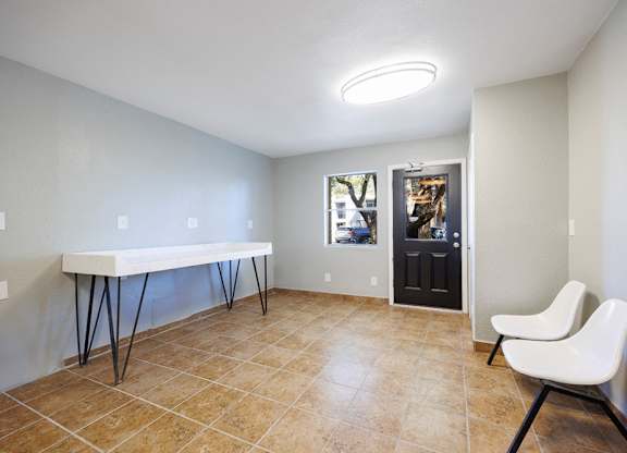 A room with a white table and a white chair.