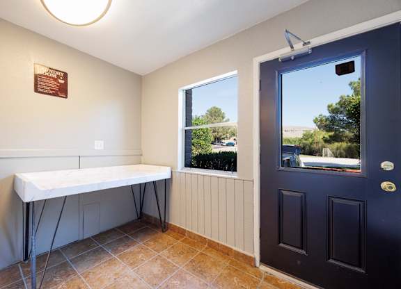 A room with a table and a window with a view of the outside.