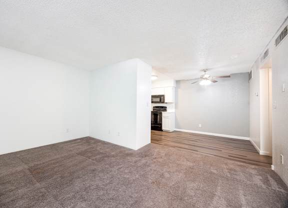 A room with a brown carpet and a white ceiling.
