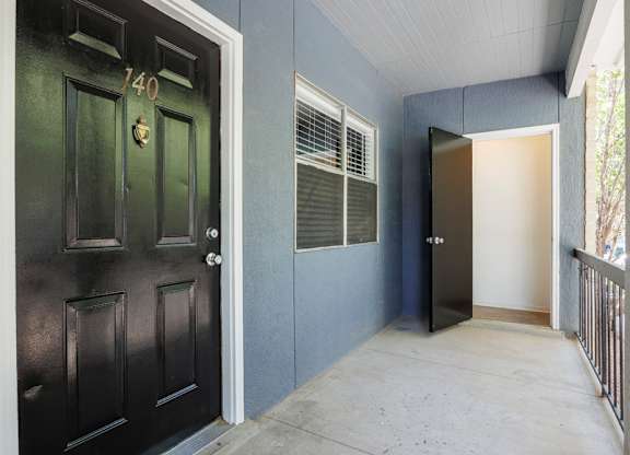 A black door with the number 140 on it.