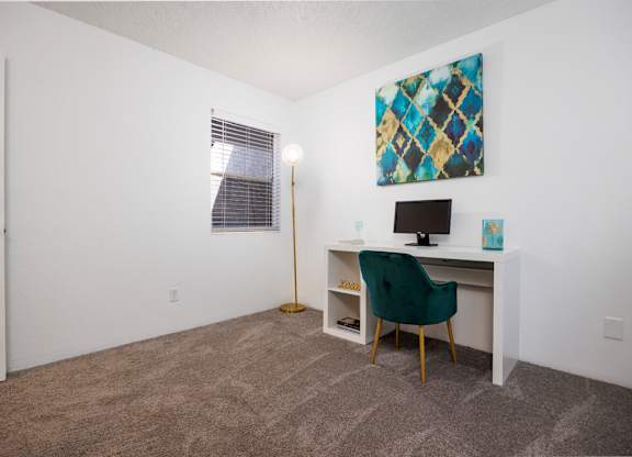 A room with a desk and a chair.