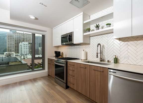 A modern kitchen with wooden cabinets and a stainless steel dishwasher.