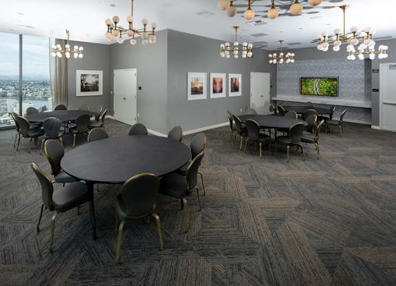 A conference room with a large table surrounded by chairs.