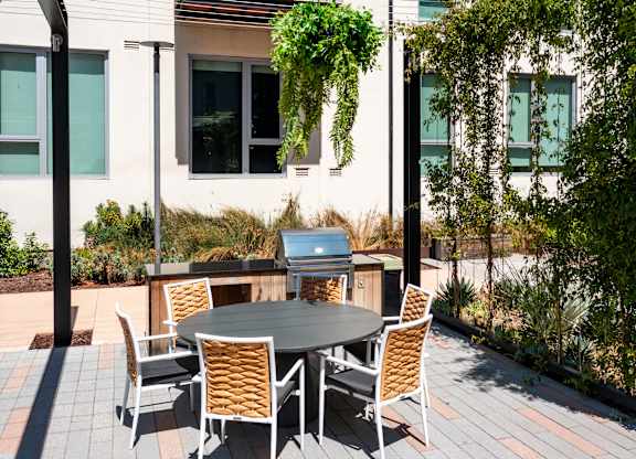 A table with chairs is set up outside on a patio.
