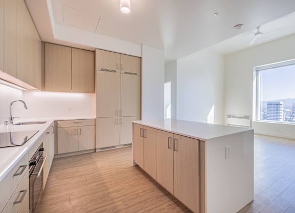 A kitchen with wooden floors and white appliances.