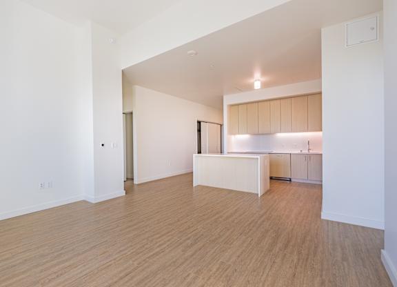 A kitchen area with a counter and cabinets.