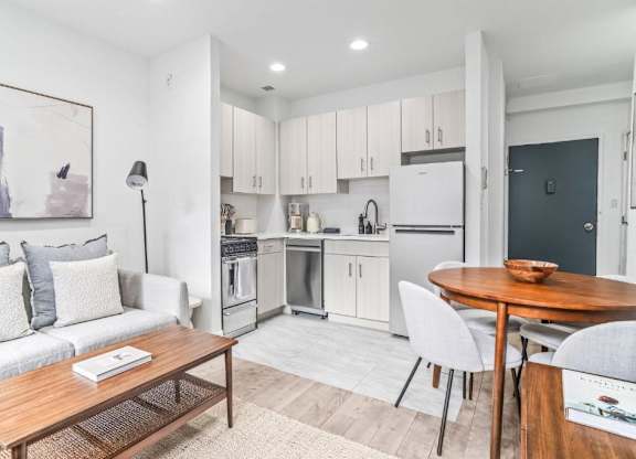 A modern kitchen with a dining table and chairs.