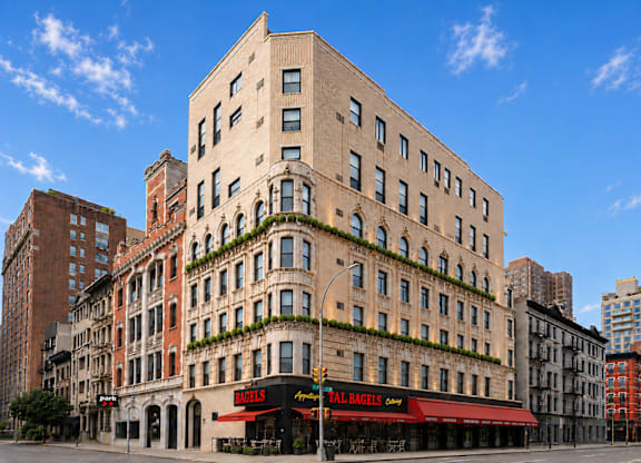 A tall building with a red awning that says "Hell's Kitchen".