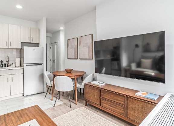 A modern kitchen with a dining table and chairs.