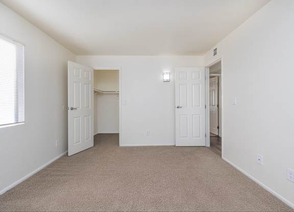 A room with white walls and carpeted floor.