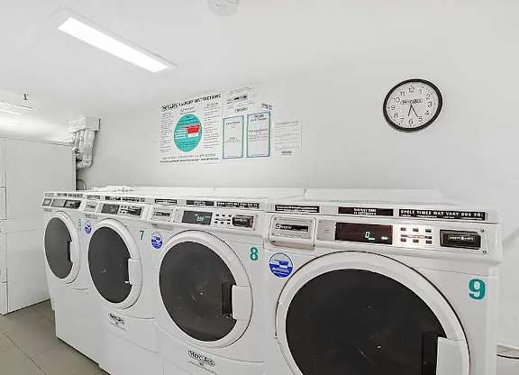 A row of washing machines in a laundromat.