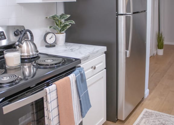 a small kitchen with stainless steel appliances and white cabinets