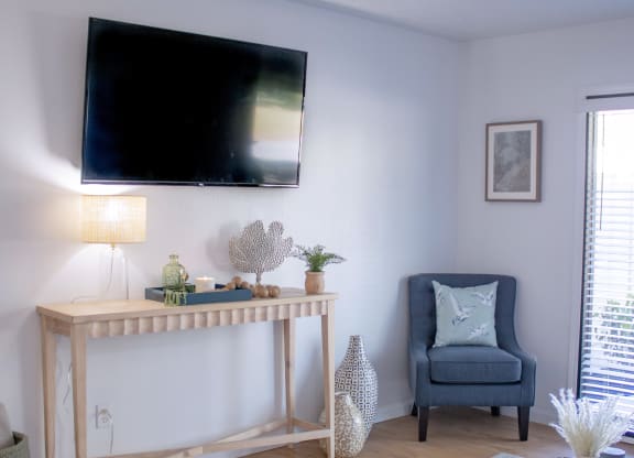 a living room with a tv on the wall