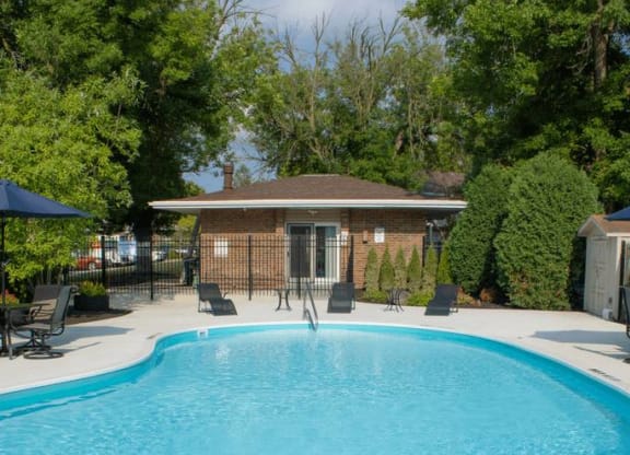 a large swimming pool in front of a house