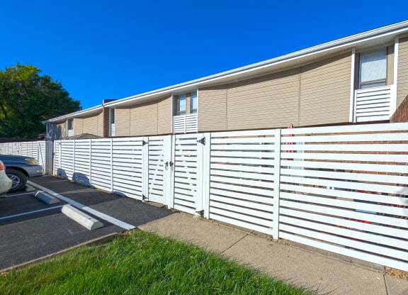 a white privacy fence in front of a house