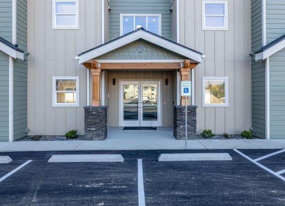 the front entrance of a building with a parking lot at Sagecrest Apartments, Wenatchee, Washington