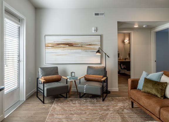 a living room with a couch and chairs and a coffee table at Sagecrest Apartments, Washington, 98801