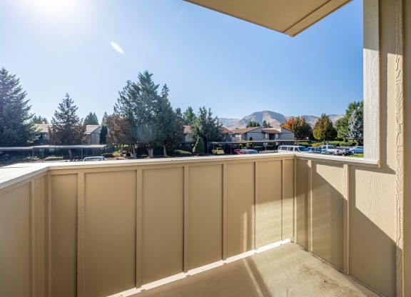 the view from the balcony of a condo with a view of the street and trees at Sagecrest Apartments, Wenatchee, Washington