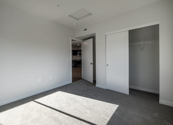 a view of a hallway with white pillars and a gray floor at Sagecrest Apartments, Wenatchee, 98801