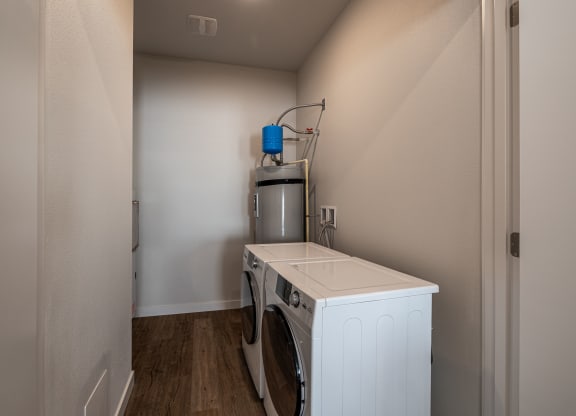 a laundry room with a washer and dryer in a house at Sagecrest Apartments, Wenatchee, WA