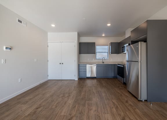 kitchen with stainless steel appliances and a wooden floor at Sagecrest Apartments, Washington, 98801