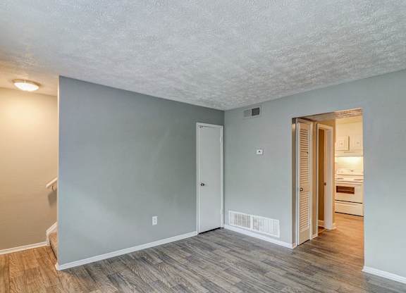 A room with a wooden floor and a white ceiling.at Waverly Manor Townhomes, Norcross, GA  