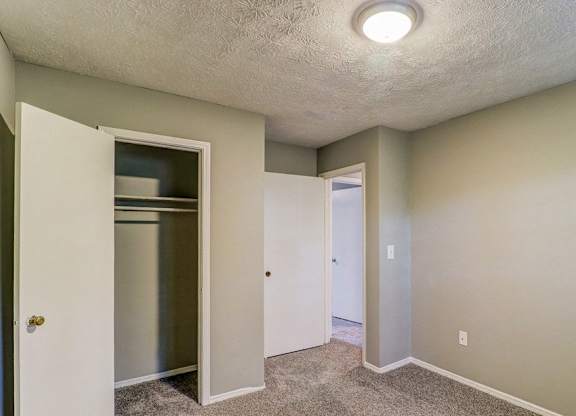 A small, empty room with a white door and a white cabinet.at Waverly Manor Townhomes, Norcross  