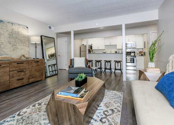 A living room with a couch, a coffee table, and a map on the wall.
