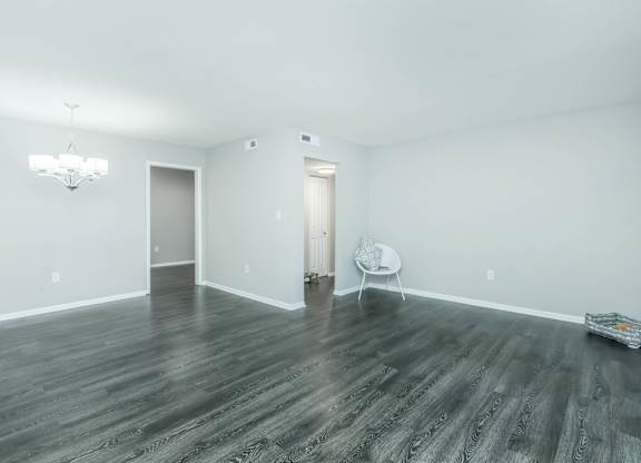 A room with a wooden floor and a white chair at Crest at East Cobb Apartments, Marietta, GA