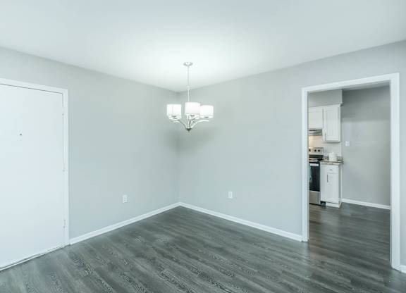 A room with a white door and a chandelier at Crest at East Cobb Apartments, Marietta, Georgia