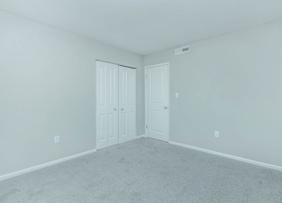 A room with two doors and carpeted floor at Crest at East Cobb Apartments, GA, 30062