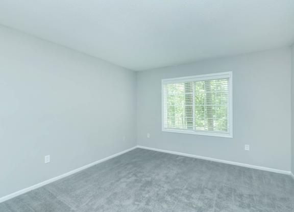 A room with a window and a grey floor at Crest at East Cobb Apartments, Georgia, 30062