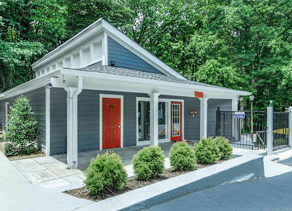 A small house with a red door and a grey roof at Crest at East Cobb Apartments, Georgia