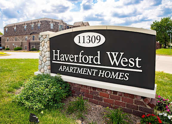 A sign for Haverford West Apartment Homes in front of a building.