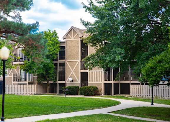 A building with a white fence in front of it.