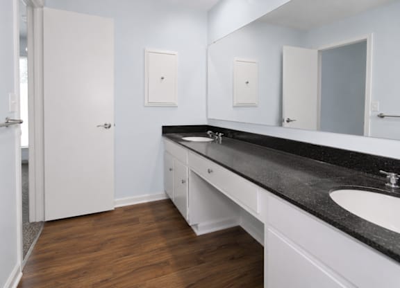 A bathroom with a sink, mirror, and medicine cabinet.