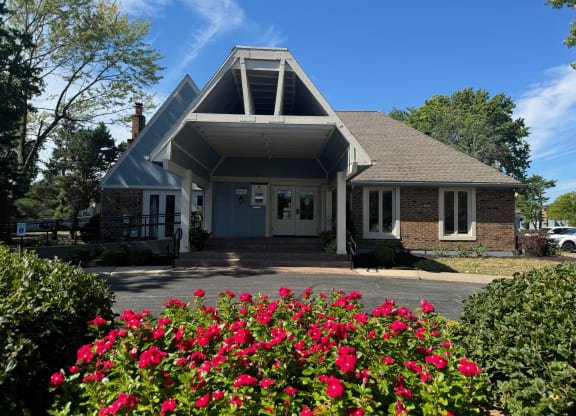 the front of a house with pink roses in the front yard at The Ridge Overland Park, Overland Park, KS, 66212