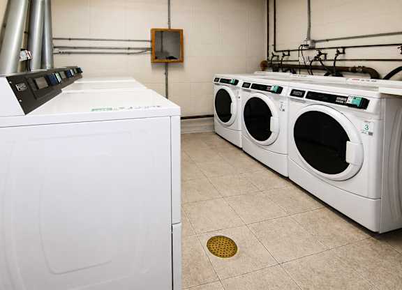 A white dryer and washing machine in a laundry room.
