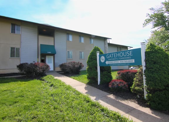 a building with a gate house sign in front of it at Gatehouse Apartments, Kansas City, MO, 64134