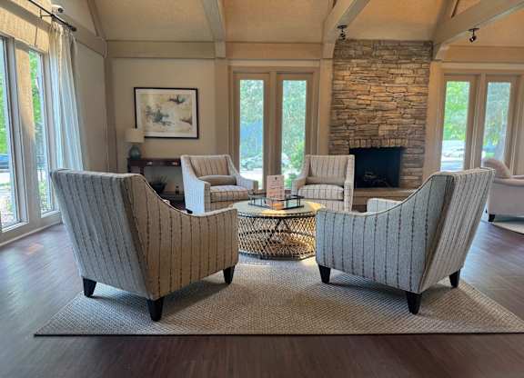 A living room with a fireplace and a painting on the wall.