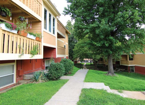 a sidewalk between two apartment buildings