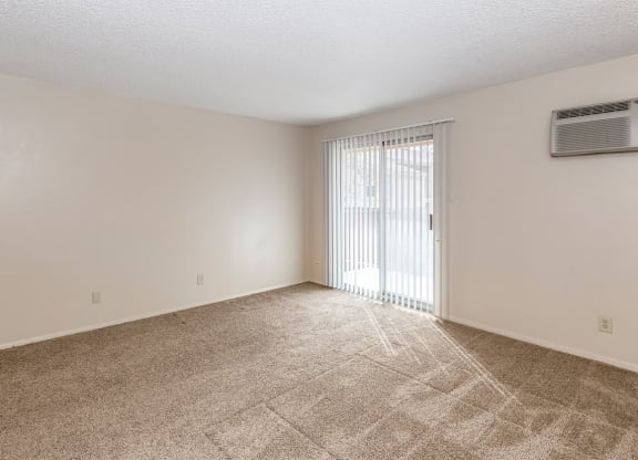 Studio Living Space and Balcony Door at Raintree Apartments, Topeka, KS, 66614