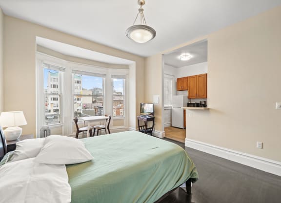 a bedroom with a bed and a large window