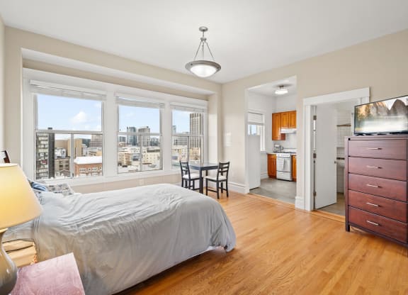 a bedroom with a bed and a dresser and a window