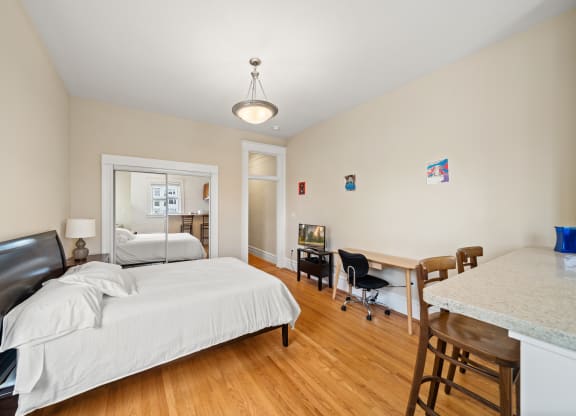 a bedroom with a bed and a desk with a chair